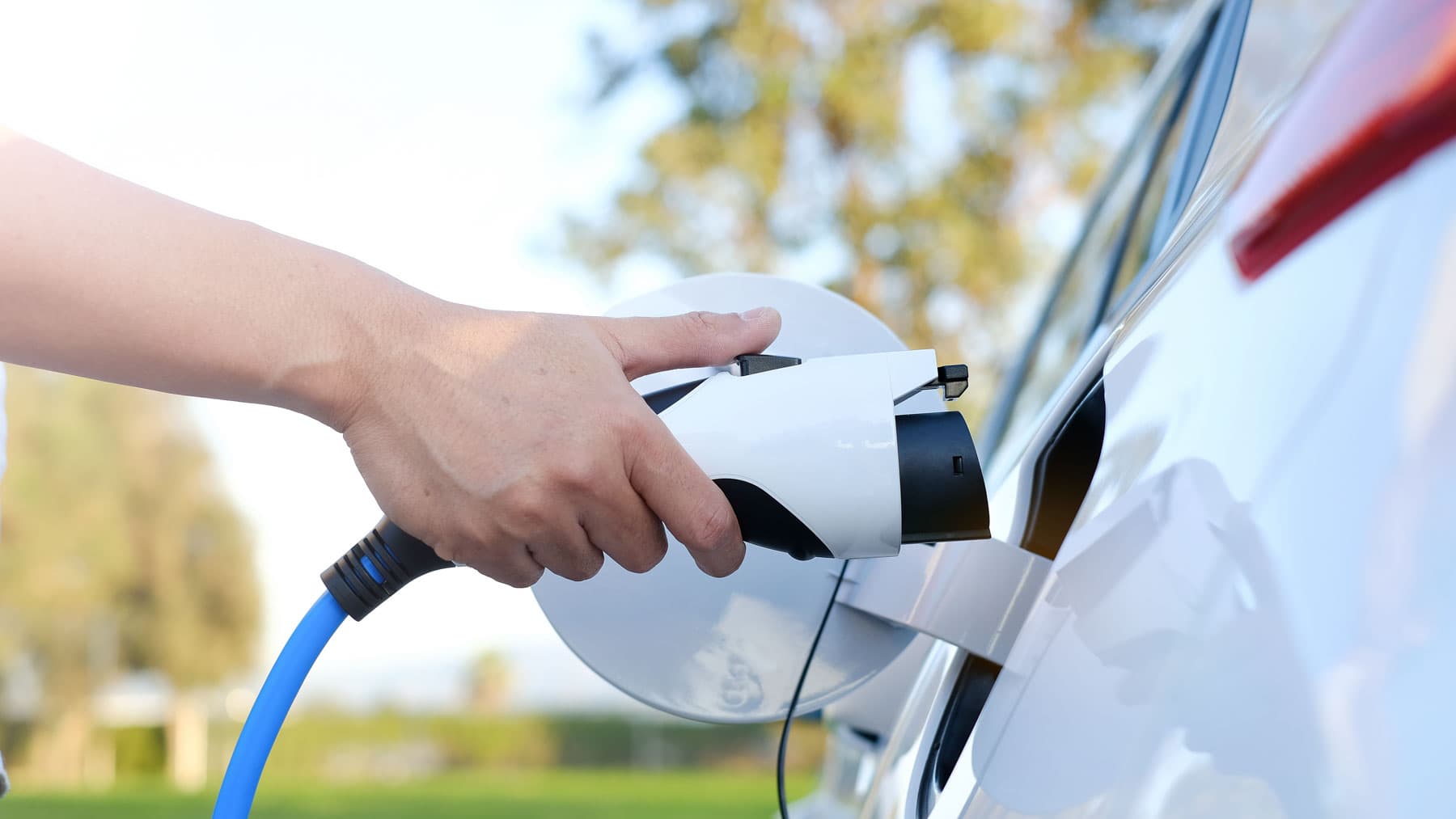 Plugging in an EV charger at a Surrey home